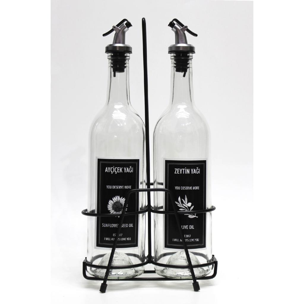 2 Transparent 750 Ml Labeled Oil Bottles And Black Stand